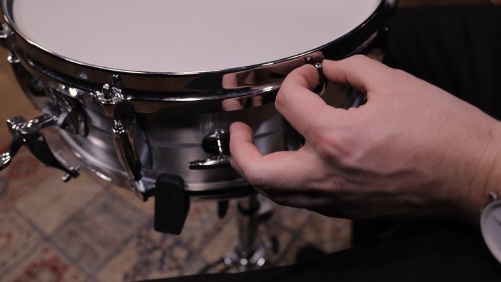 Man Replacing the Snare Drum Head